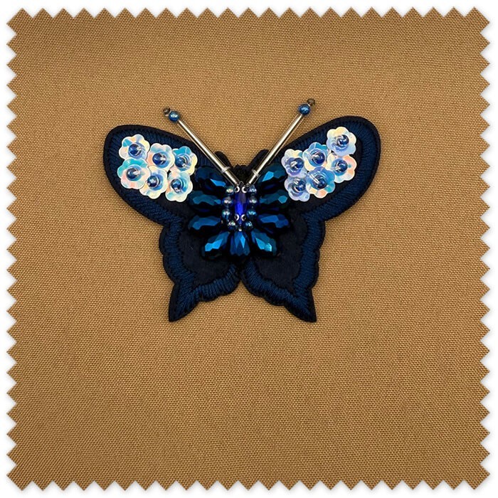 Parche decorativo mariposa para coser
Aplicación textil mariposa azul elegante